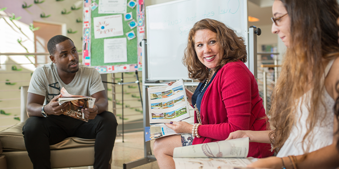 Female professor and two students in a classroom